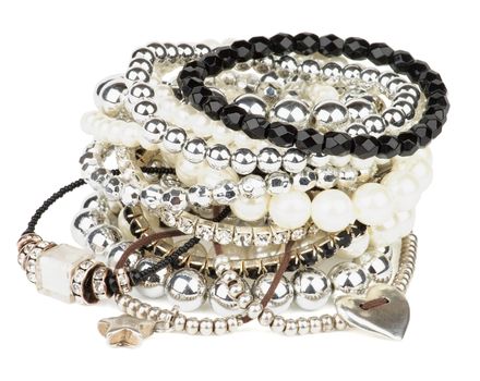 Pile of Various Pearl, Silver and Black Jewelry Gems Bracelets isolated on white background