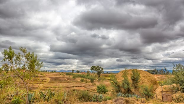 Dark clouds hovering over the farm lands of the highland areas of Madagascar