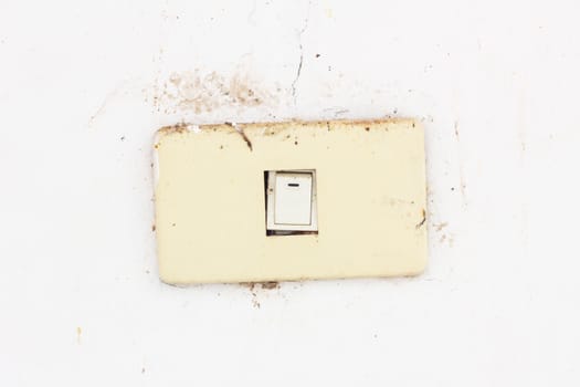 old and dirty electrical switch on dirty wall
