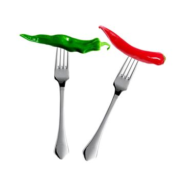 Red hot chili pepper with yellow green pepper pricked on forks isolated on white