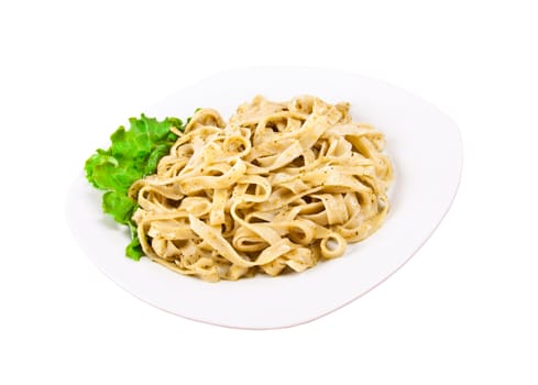 Tagliatelle pasta with pesto on white plate