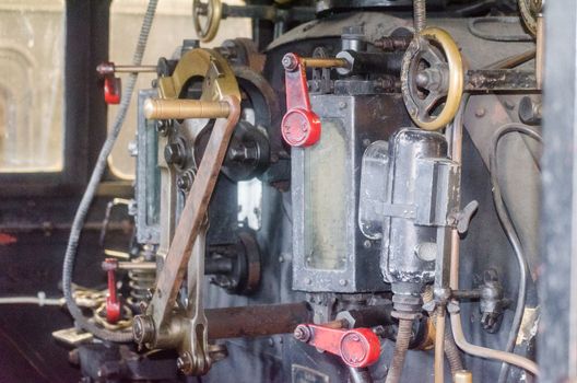 View into the cab of an old steam locomotive.