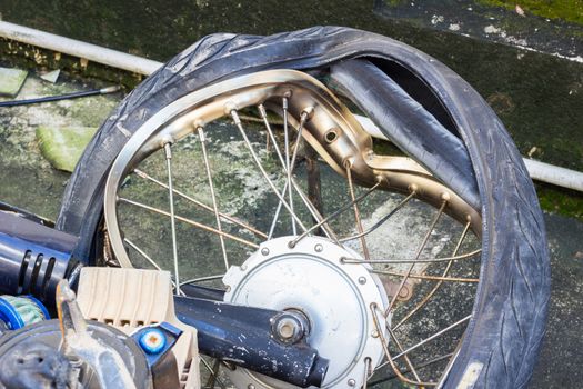 broken wheel of crashed motorcycle, accident  on the road