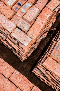 Bricks neatly stacked in square stacks by the building site.