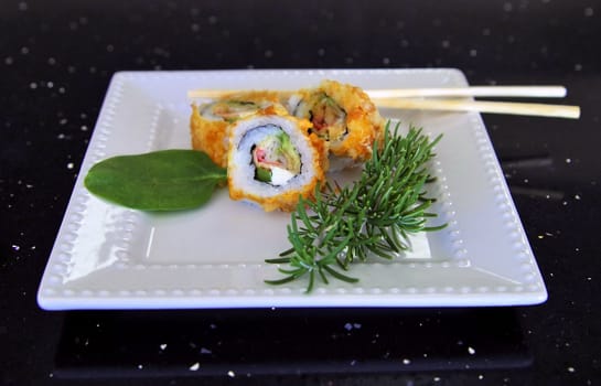 crab, avocado, and cream cheese roll with garnish and chop sticks