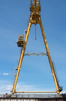 Gantry crane against the blue sky background