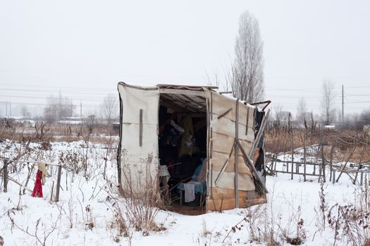 Temporary self-made shelter covered with the snow in winter.