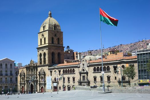 LA PAZ, BOLIVIA - OCTOBER 12, 2014: Basilica of San Francisco and the red-green flag of La Paz on the San Francisco square in the city center on October 12, 2014 in La Paz, Bolivia