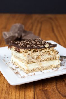 A layered Boston creme pie style dessert made with french vanilla filling and chocolate ganache topping.