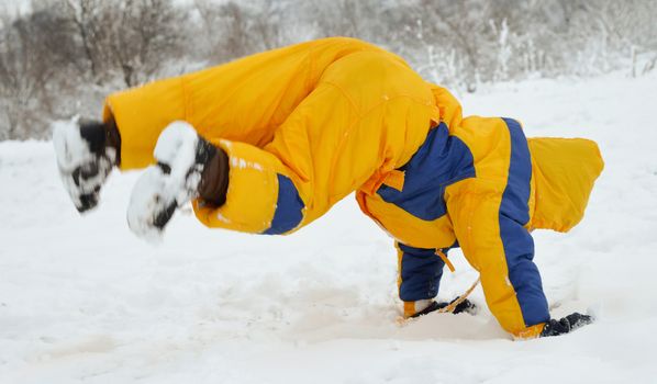 Cute little boy playing in the snow