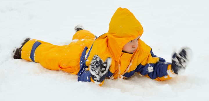 Cute little boy playing in the snow