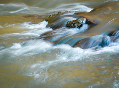 background fall color toned water still life on a wild river