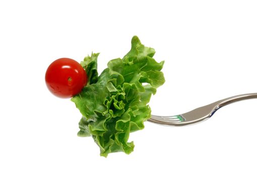 Fresh salad and cherry tomato on fork