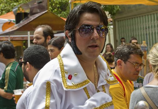 SAO PAULO, BRAZIL - JANUARY 31, 2015: An unidentified man dressed like Elvis Presley participate in the annual Brazilian street carnival dancing and singing samba.