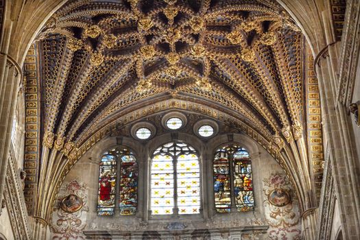 Stone Arch Stained Glass Jesus Angels Statues New Salamanca Cathedral Spain.  The New and Old Cathedrals in Salamanca are right next to each other.  New Cathedral was built from 1513 to 1733 and commissioned by Ferdinand V of Castile, Spain.