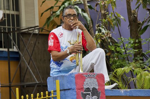 SAO PAULO, BRAZIL - JANUARY 31, 2015: An unidentified man with a trumpet of a traditional samba band participate in the annual Brazilian street carnival.