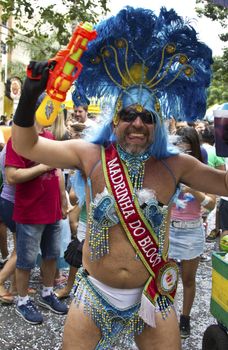 SAO PAULO, BRAZIL - JANUARY 31, 2015: An unidentified man dressed like a woman participate in the annual Brazilian street carnival dancing and singing samba.