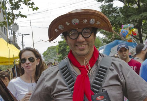 SAO PAULO, BRAZIL - JANUARY 31, 2015: An unidentified man dressed like a old outlaw participate in the annual Brazilian street carnival dancing and singing samba.