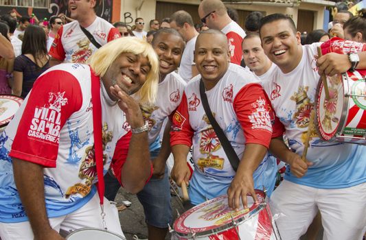 SAO PAULO, BRAZIL - JANUARY 31, 2015: An unidentified men group playing drums in a traditional samba band participate at the annual Brazilian street carnival.