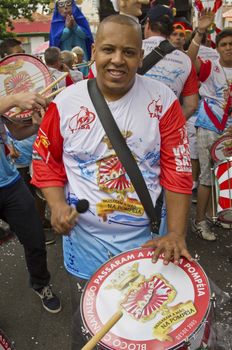 SAO PAULO, BRAZIL - JANUARY 31, 2015: An unidentified man playing drum in a traditional samba band participate at the annual Brazilian street carnival.