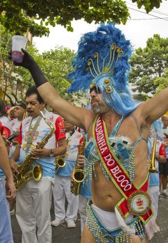 SAO PAULO, BRAZIL - JANUARY 31, 2015: An unidentified man dressed like a woman participate in the annual Brazilian street carnival dancing and singing samba.