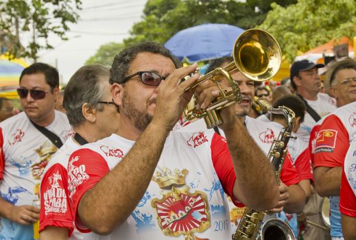 SAO PAULO, BRAZIL - JANUARY 31, 2015: An unidentified man playing trumpet in a traditional samba band participate in the annual Brazilian street carnival.