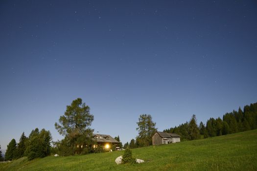 Starry sky over the hill in the dolomites, summer season