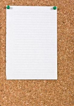 White lined paper pinned to a cork notice board.