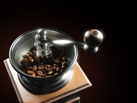 coffee grinder with grains on a black background