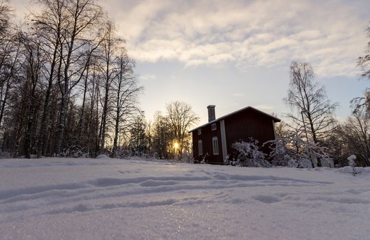 Traditional Swedish House in Winter Sunset