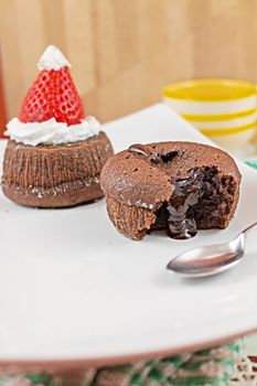 Tasty chocolate cupcakes with a red strawberry