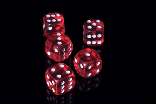 Five red casino dices on the black background
