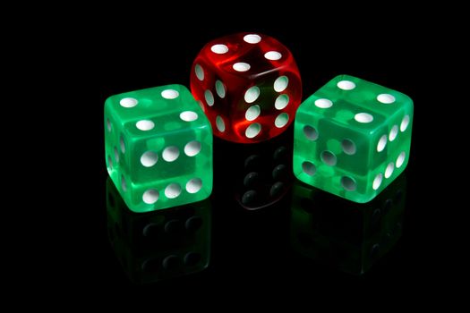 Three casino dice on a black background