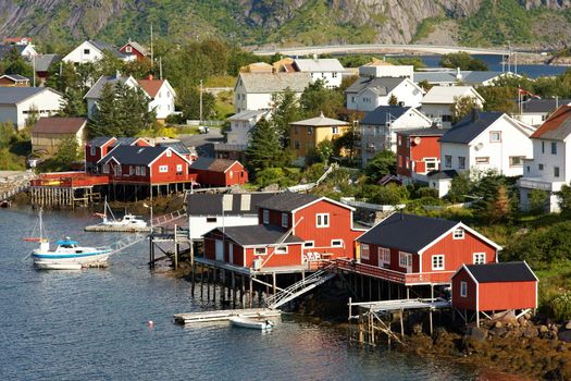 Fishing village on Lofoten islands in Norway with typical red wooden buildings