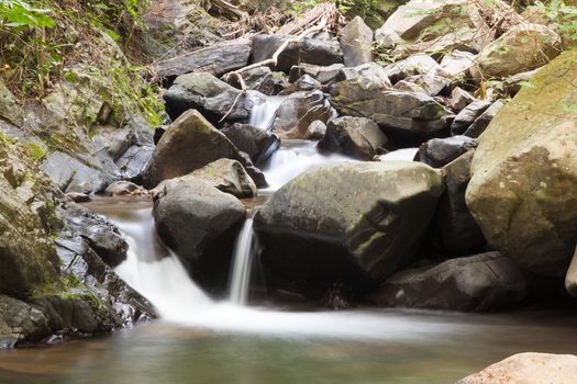 Waterfall that flows down from the mountains. Streams of water flowing down from the mountains. There is always a small stone waterfall.