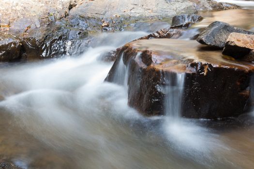 Waterfall that flows down from the mountains. Streams of water flowing down from the mountains. There is always a small stone waterfall.