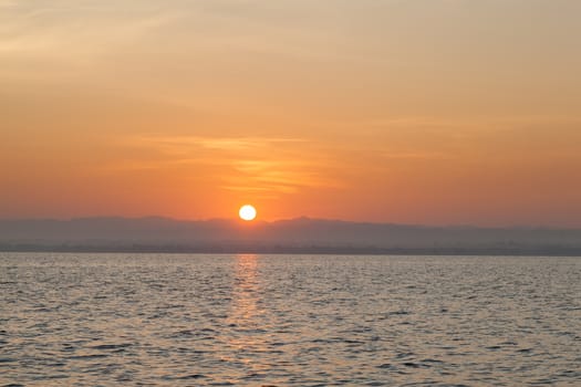 Sunrise in the morning. In front of a water storage dams. And clear skies in the morning.