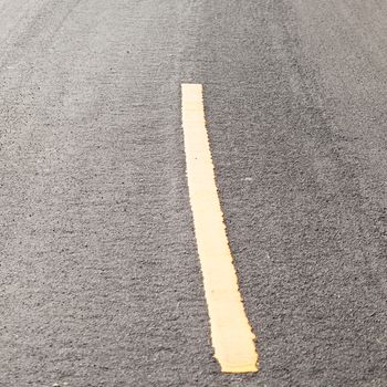 Yellow symbols on the road. A corner on the street is the yellow curve.