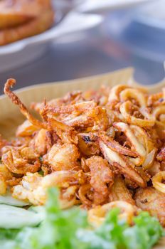 fried squids and garlic served with vegetable on  dish