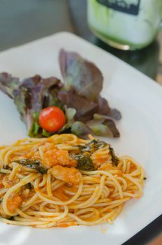 close up pasta with tomato sauce , shrimp and vegetable on dish