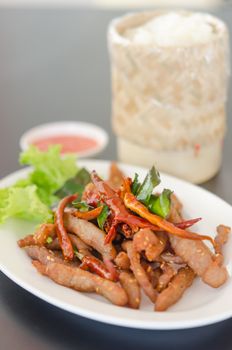 Closeup of fresh fried meat with sesame and chili