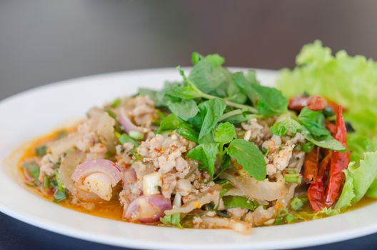 spicy minced pork eaten with fresh vegetable on plate , asian food