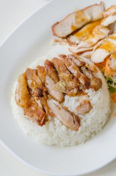 close up fried Chicken over steamed rice on plate