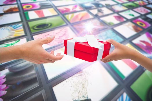Couple passing a wrapped gift against screen collage showing lifestyle images