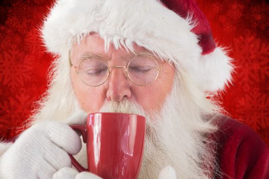 Santa drinks from a red cup against red paint splatter background