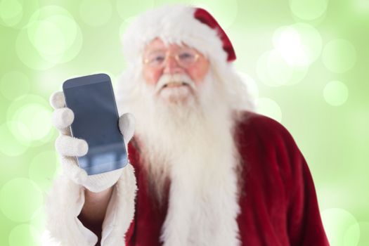 Santa Claus shows a smartphone against green abstract light spot design