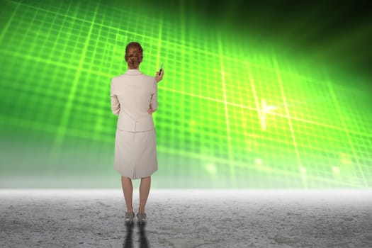 Thinking businesswoman against green glowing technology grid above desert