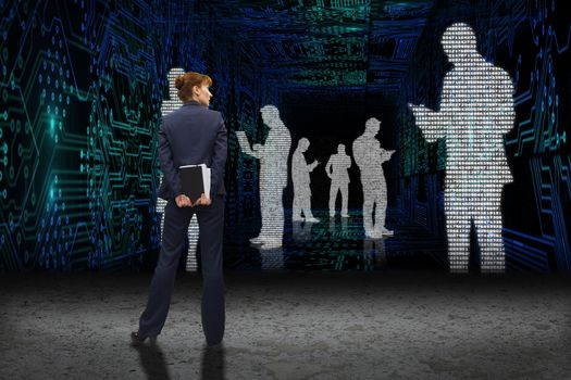 Businesswoman looking against business people in data matrix