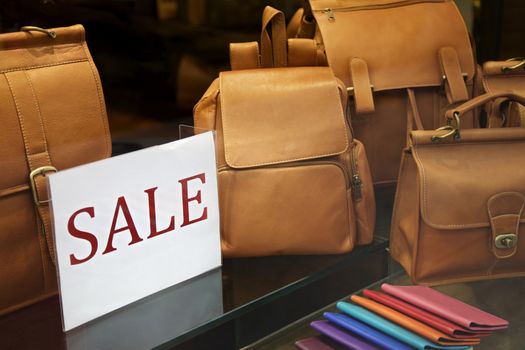 Sale sign in a shopping window, handbags and wallets, New York, USA