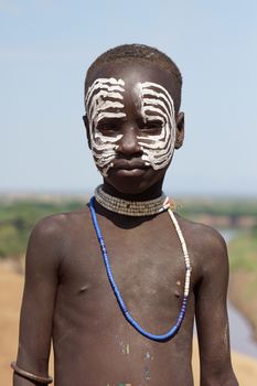 TURMI, ETHIOPIA - NOVEMBER 19, 2014: Karo Boy with traditional paintings on November 19, 2014 in Turmi, Ethiopia.